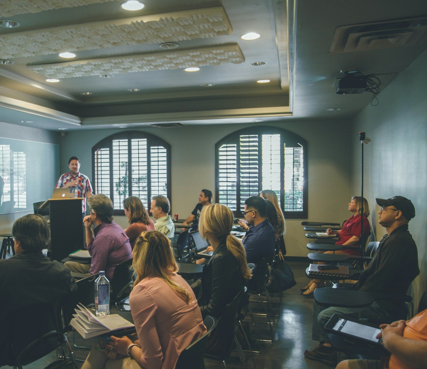 A presenter teaching a room of small-business owners